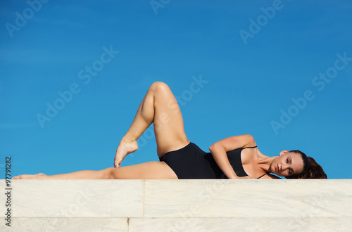 Young beautiful ballerina dancing outdoors in a modern environment.