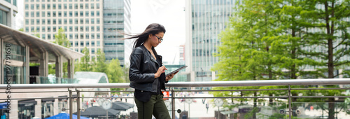 Panoramic image of young mixed race businesswoman portrait outdoors in Canary Wharf in London.