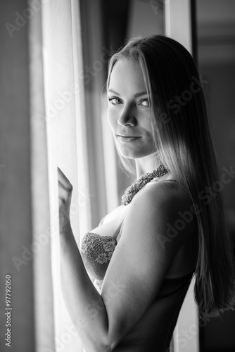 Sensual young blonde woman portrait wearing lingerie in hotel room