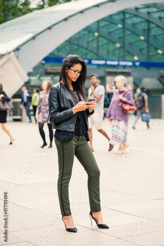 Young mixed race businesswoman portrait outdoors in Canary Wharf. London.