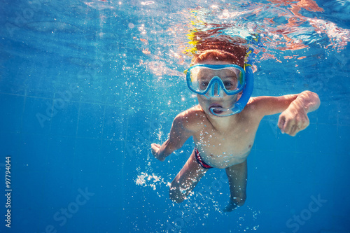 Underwater kid in swimming pool with mask.