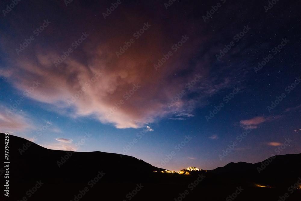 Night stars over Castelluccio village and Sibillini mountains in Italy. Night stars over Castelluccio village and Sibillini mountains in Italy.