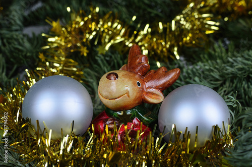 The tiny reindeer between the silver Christmas  balls