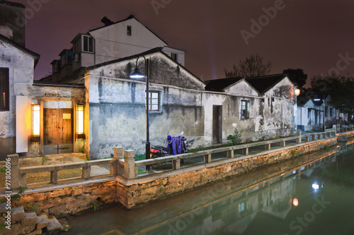 Waterway in traditional neighborhood at night, Suzhou, China