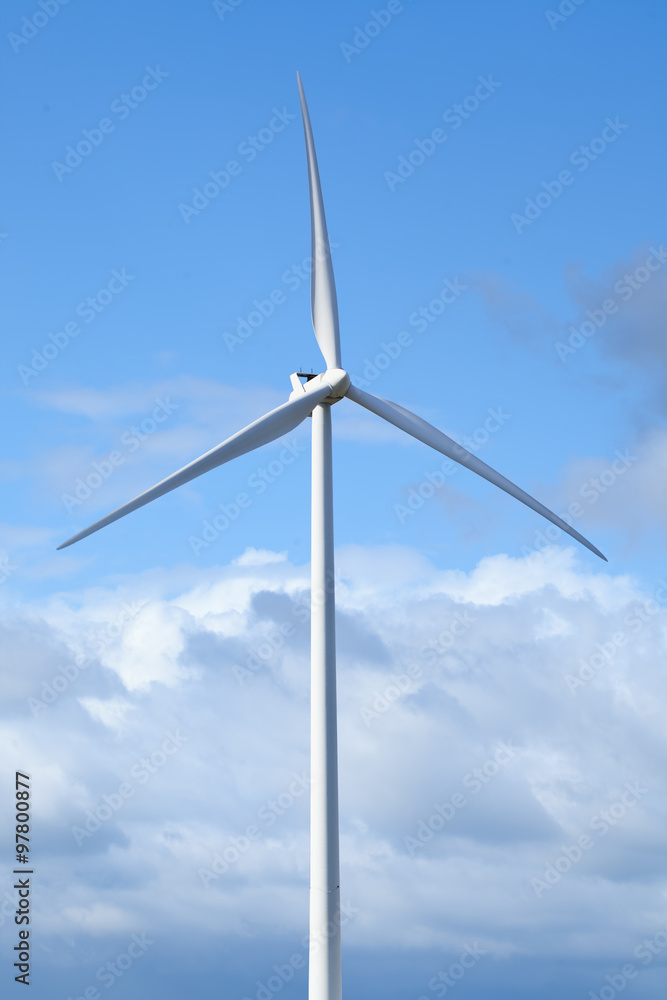 White modern windmill against a cloud sky. White modern windmill against a cloud sky.