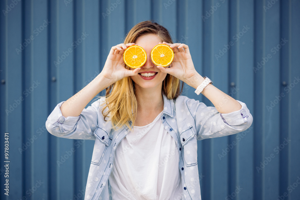 Smiling woman holding two orange in hands Smiling woman holding two orange in hands