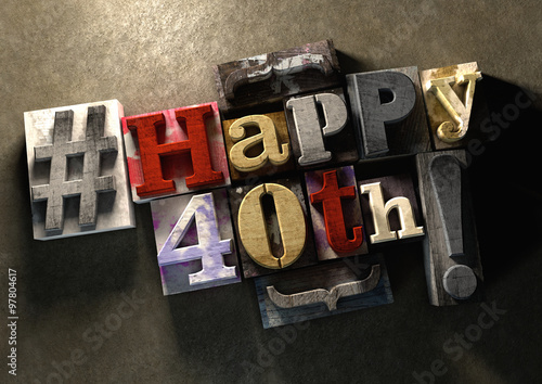 Ink splattered printing wood blocks with Happy 40th birthday grungy typography title photo