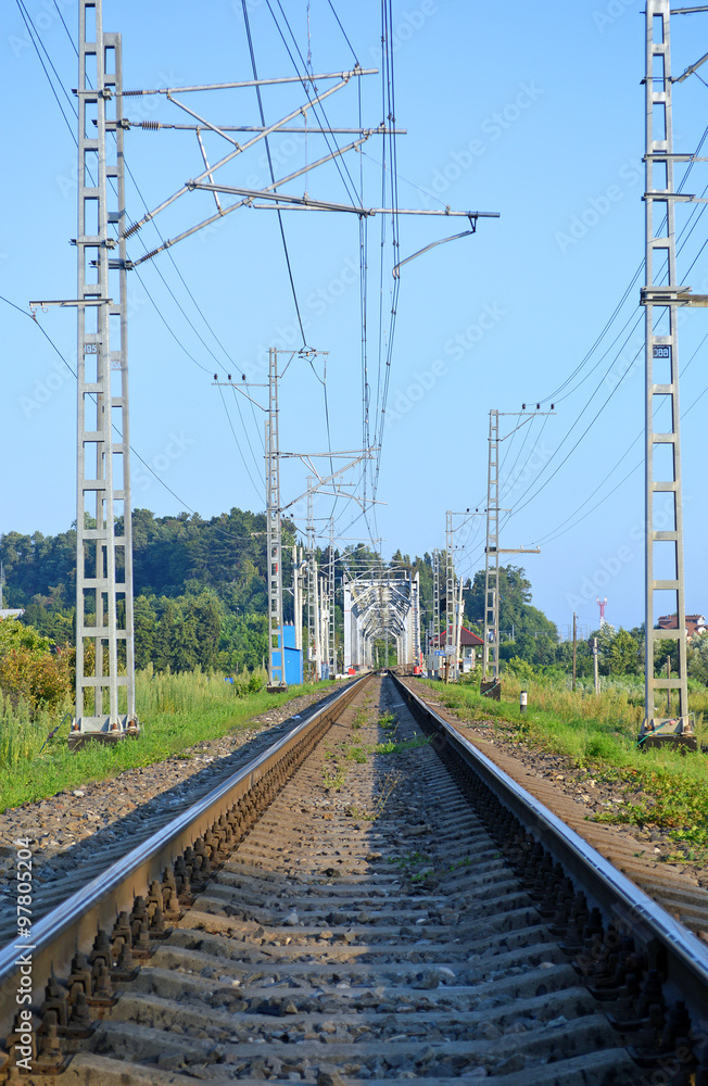 Fototapeta premium Однопутный участок железной дороги по направлению к железнодорожному мосту