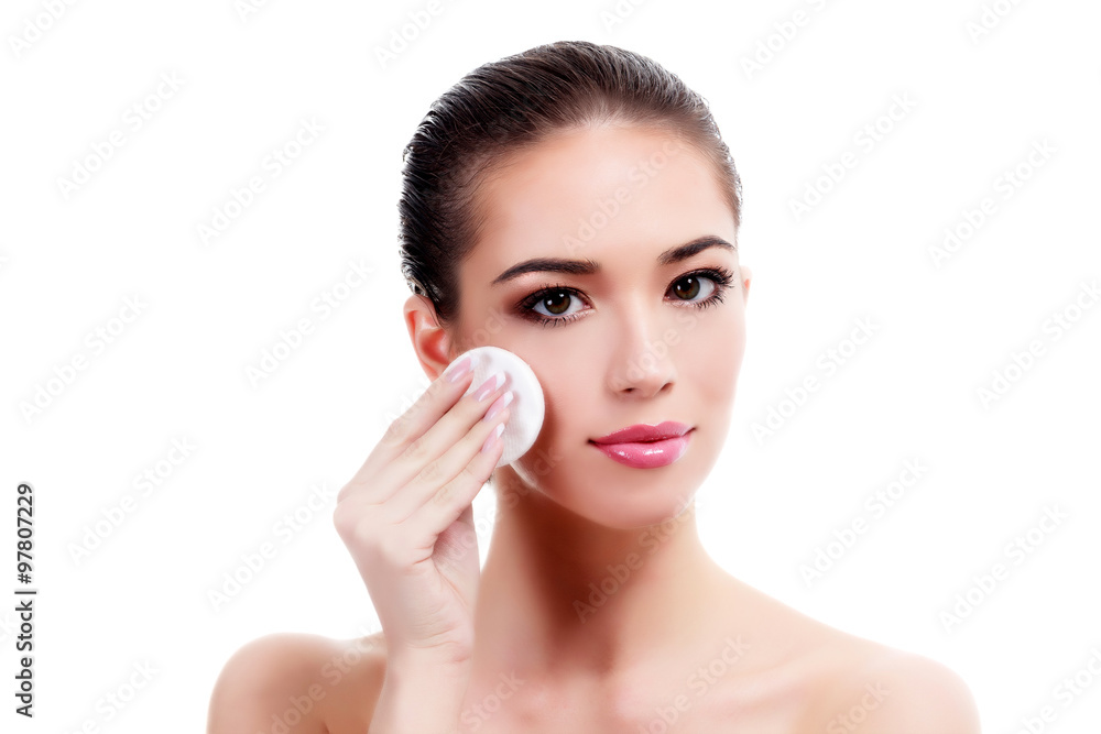 Beautiful woman using a cotton pad, isolated on white Beautiful woman using a cotton pad, isolated on white