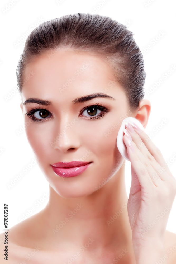 Beautiful woman using a cotton pad, isolated on white Beautiful woman using a cotton pad, isolated on white