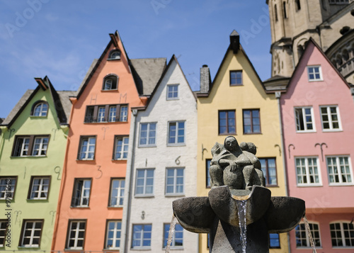 Fountain near the colorful houses in the old center of Cologne, Germany photo