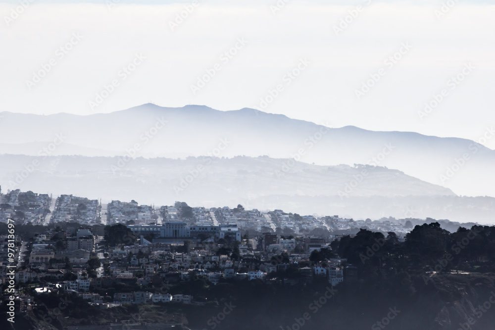 San Francisco seen from Marin Headlands, with mist and fog on the hills