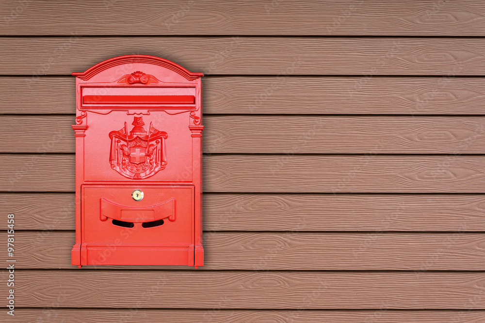 Red mailbox with wooden background with copy space