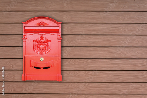 Red mailbox with wooden background with copy space