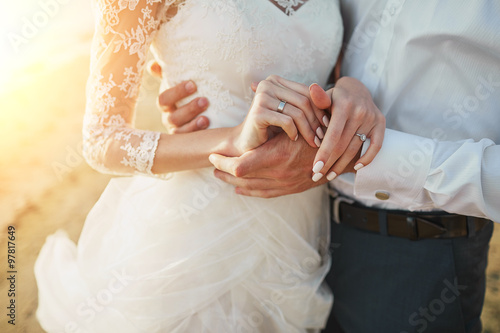 Photos Just married couple running on a sandy beach