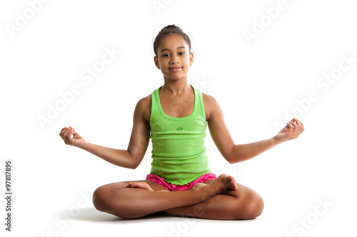 Little girl sitting in lotus position and hands up isolated on white background