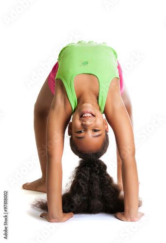 Obraz na płótnie beautiful dark-skinned girl performs a gymnastic exercise