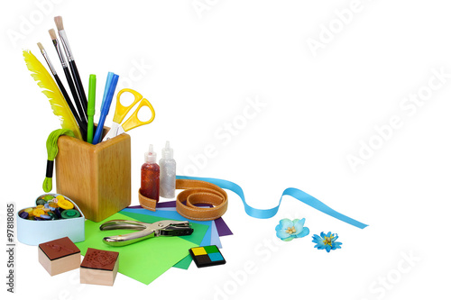 Assorted scrapbooking or card making supplies, isolated on white background with soft shadows. Copy space provided. photo