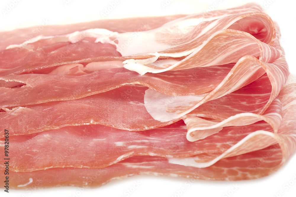 Italian prosciutto crudo ,raw ham leg sliced on white Italian prosciutto crudo ,raw ham leg sliced on white