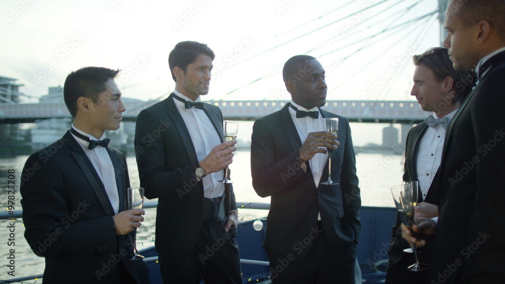Male friends or business colleagues, chatting at formal social event Male friends or business colleagues, chatting at formal social event