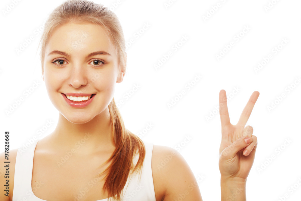 portrait of happy young woman giving peace sign portrait of happy young woman giving peace sign