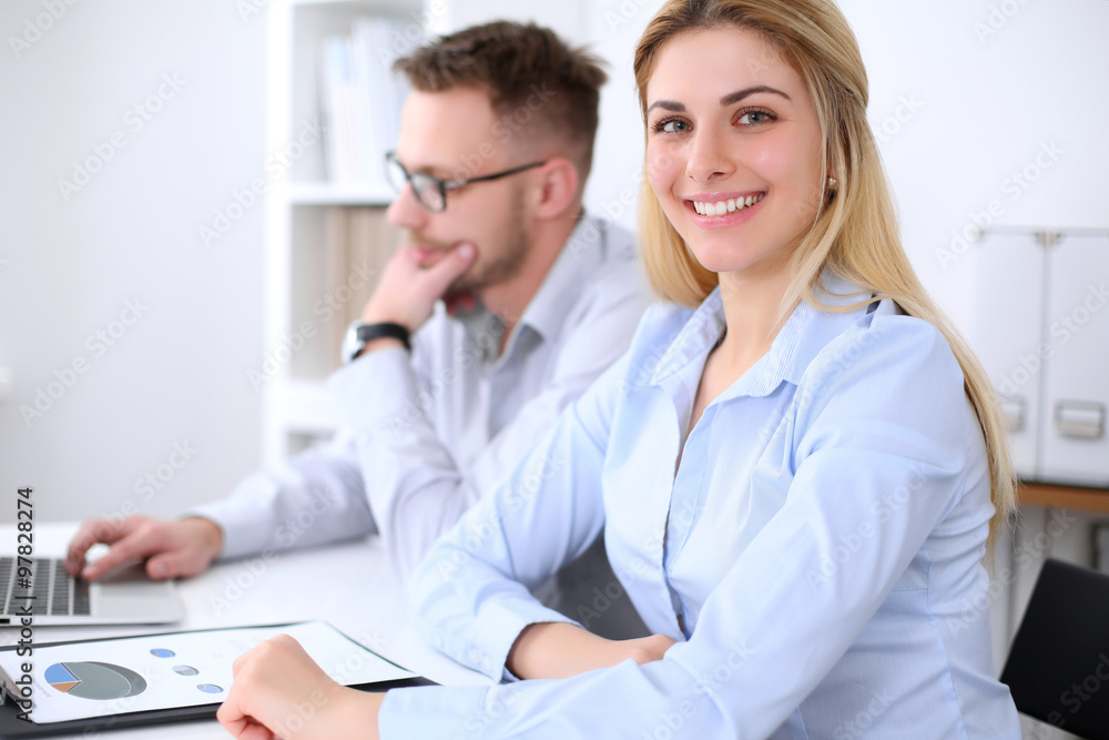 Two successful business partners working at meeting in office