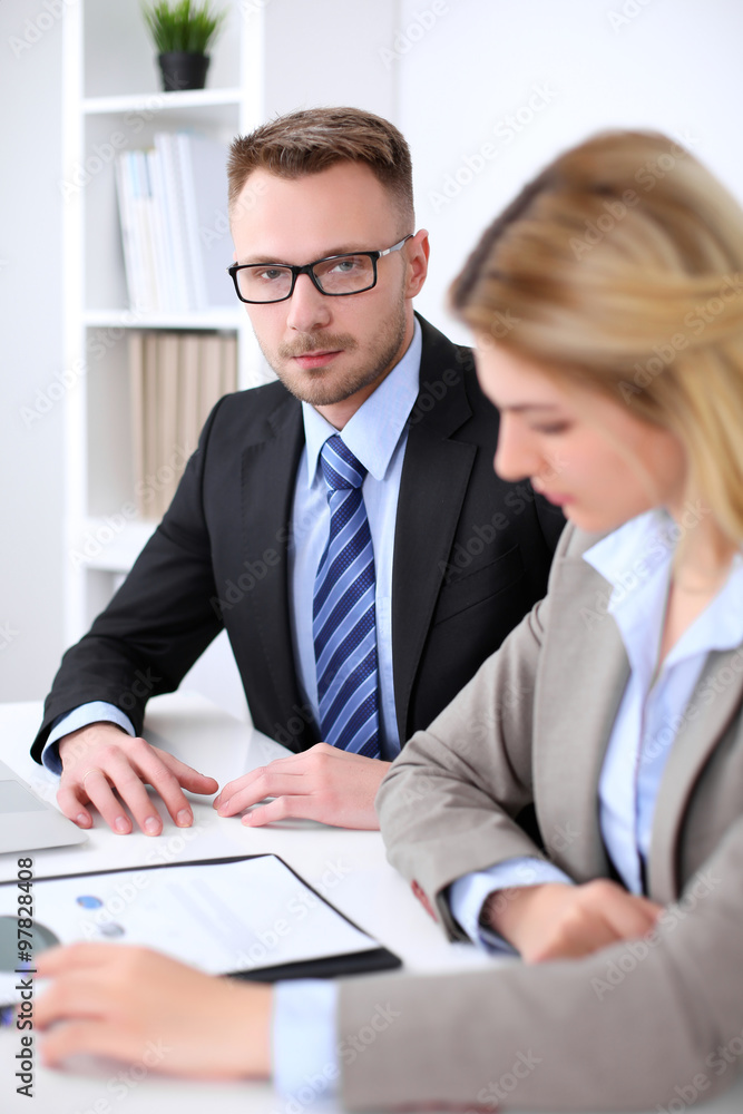 Two successful business partners working at meeting in office Two successful business partners working at meeting in office