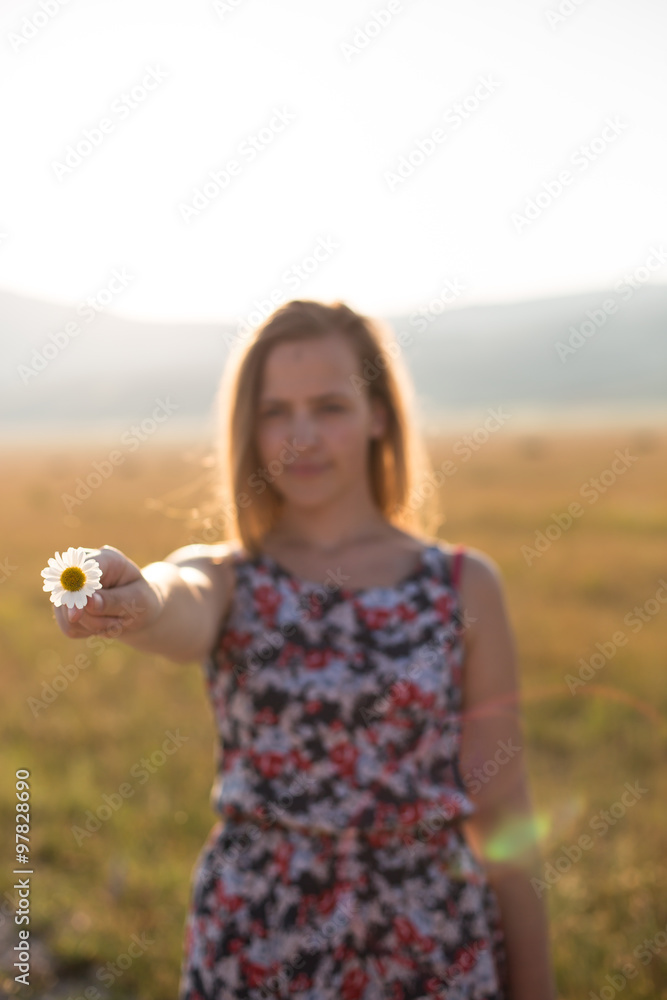 flower on woman hand, sunset on mountain flower on woman hand, sunset on mountain