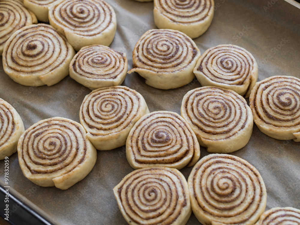 unbaked danish rolls on a griddle on the way to the oven