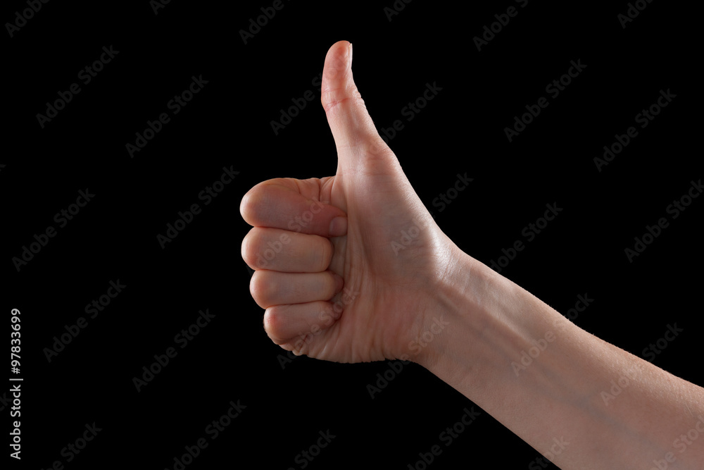 Approval thumbs up like sign as caucasian hand gesture isolated over black Approval thumbs up like sign as caucasian hand gesture isolated over black
