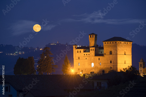 Castle of Grinzane Cavour in nocturnal with a full moon