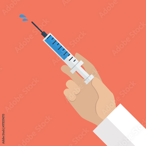 Hand holding syringe