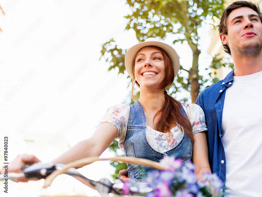 Happy couple in city with bike Happy couple in city with bike