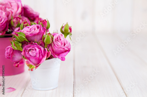 Pink roses(peony) in vase on white wooden background. flowers