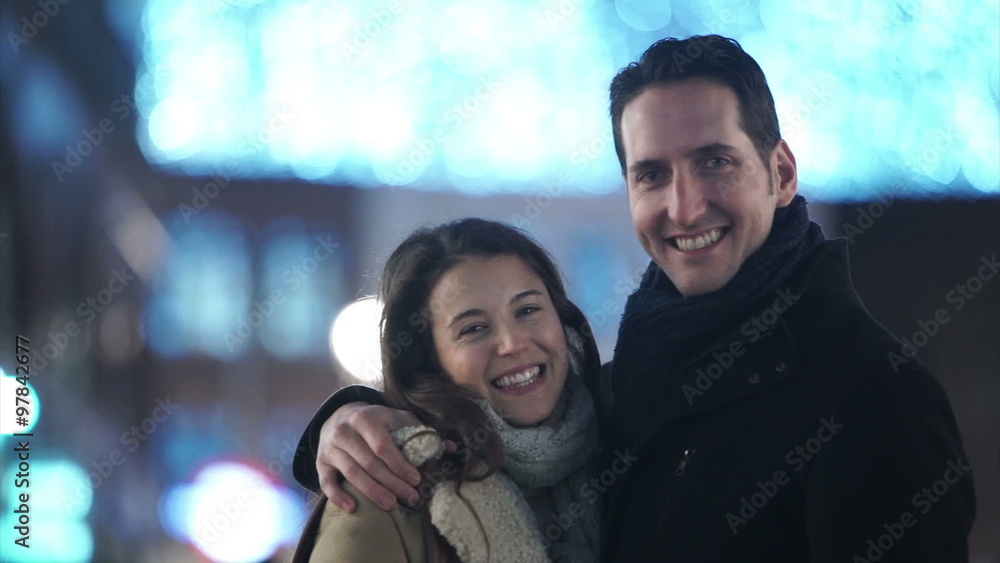Portrait of happy romantic couple on busy city street at Christmas time. Shot on RED Epic. Portrait of happy romantic couple on busy city street at Christmas time. Shot on RED Epic.