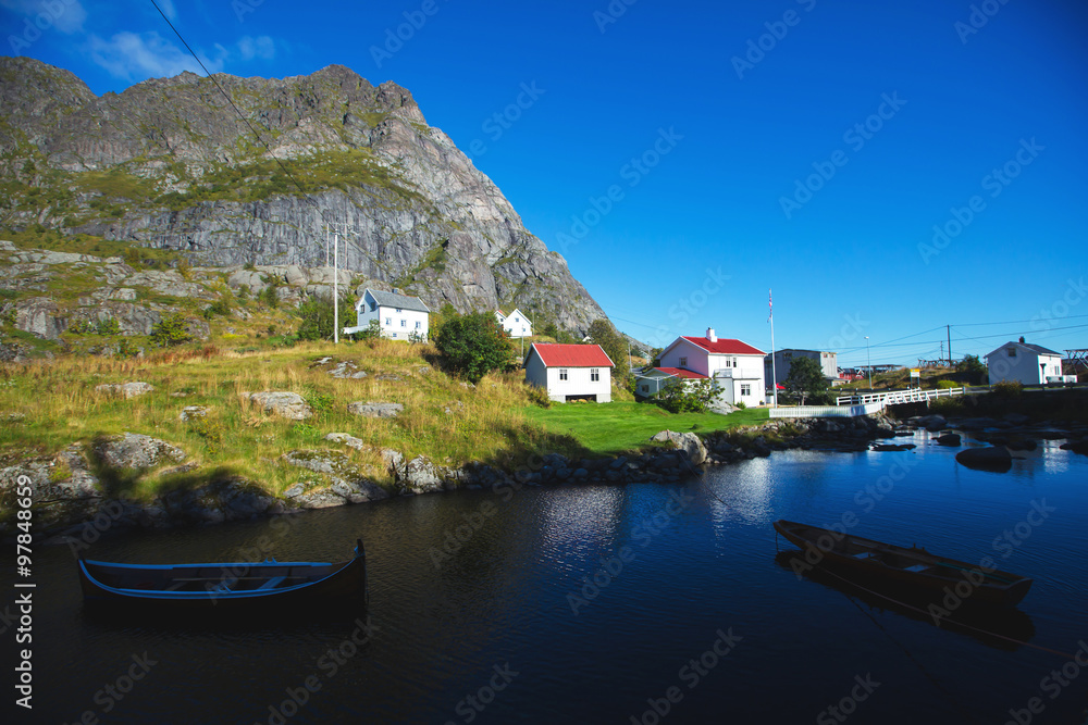Beautiful super wide-angle summer aerial view of Reine, Norway, Lofoten Islands, with skyline, mountains, famous fishing village with red fishing cabins, Moskenesoya, Nordland