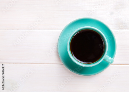 turquoise Cup of fresh coffee on white wooden table