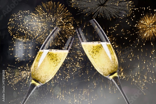 Obraz na plátne Composite image of champagne glasses clinking