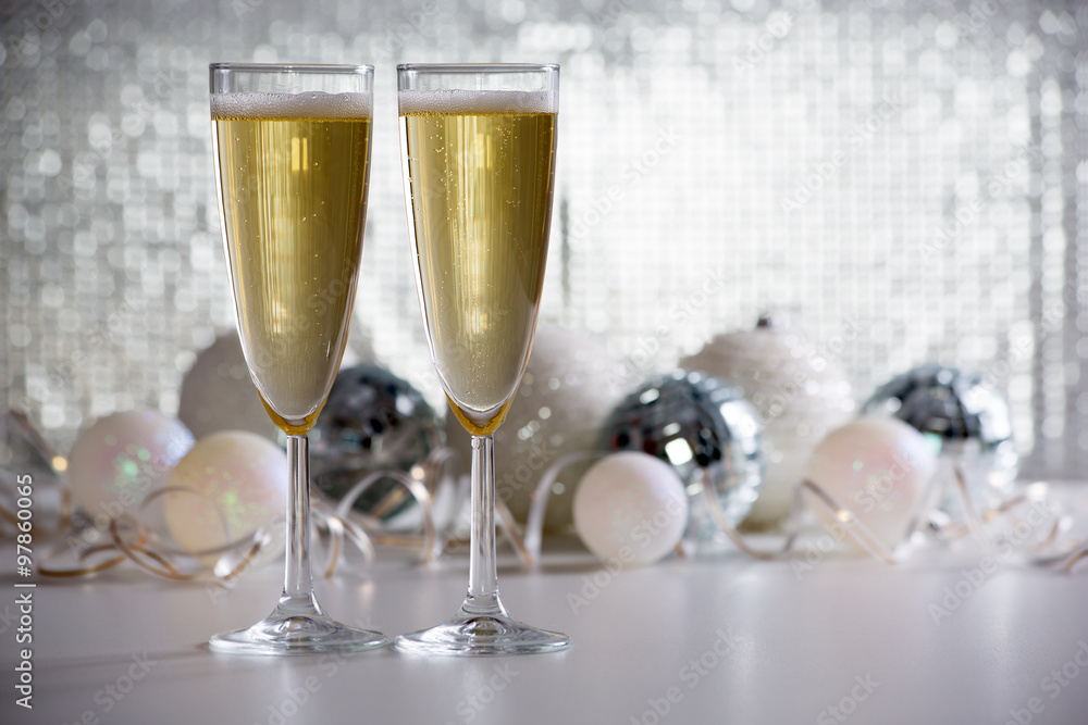 Two champagne glasses and christmas balls