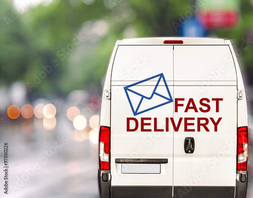 White fast delivery Van driving fast on city blurr bokeh street