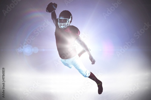 Composite image of american football player scoring a touchdown © vectorfusionart