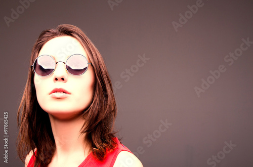 Fashion portrait of a beautiful brunette woman in glasses