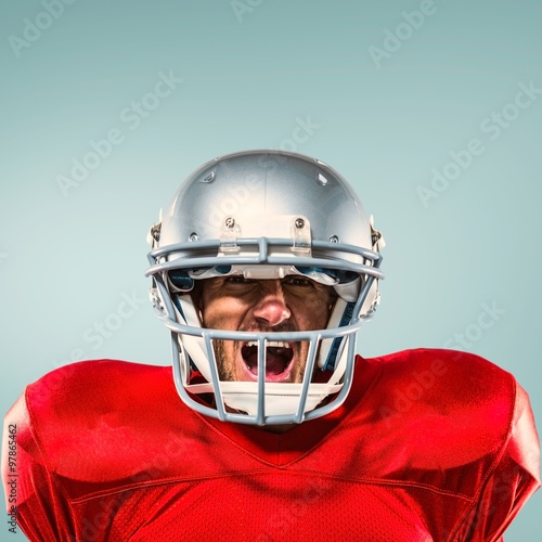 Composite image of aggressive american football player