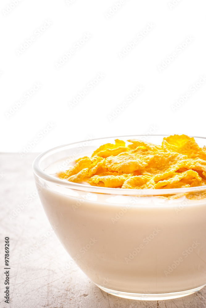Natural yogurt in glass bowl with cornflakes vertical Natural yogurt in glass bowl with cornflakes vertical