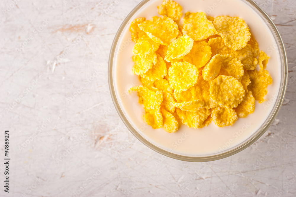 Natural yogurt in glass bowl with cornflakes top view Natural yogurt in glass bowl with cornflakes top view