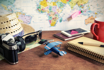 Travel and vacation accessories on wooden background