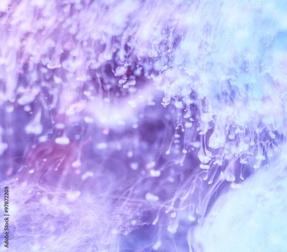 Cloudy purple and white ink in water