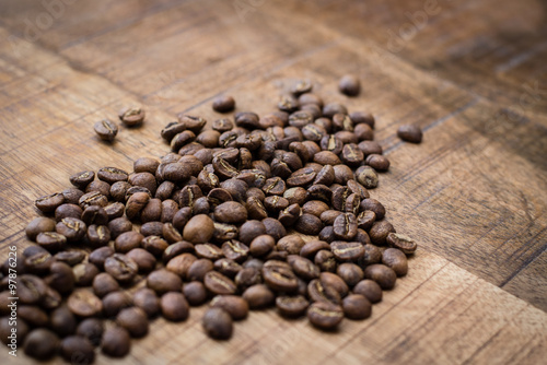 High quality coffee beans on dark wooden background.