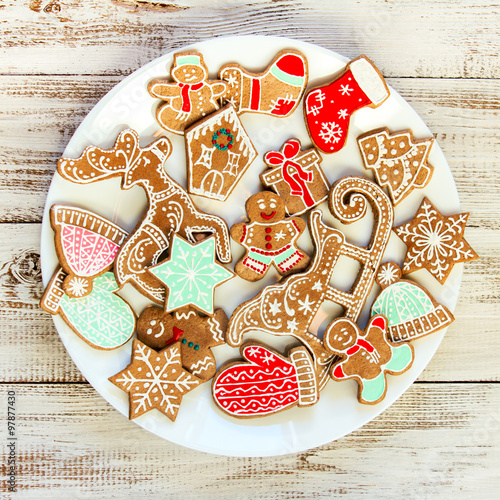 Christmas ornate gingerbread cookies on a white plate.