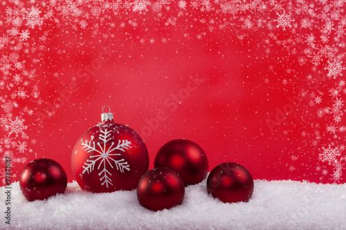 red Christmas balls in the snow